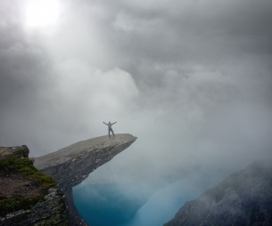 Hiker on Trolltunga with arms wide open